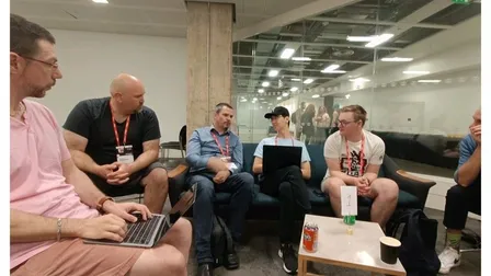 A small group sitting on couches around a low table during an unconference session at DevRelCon London